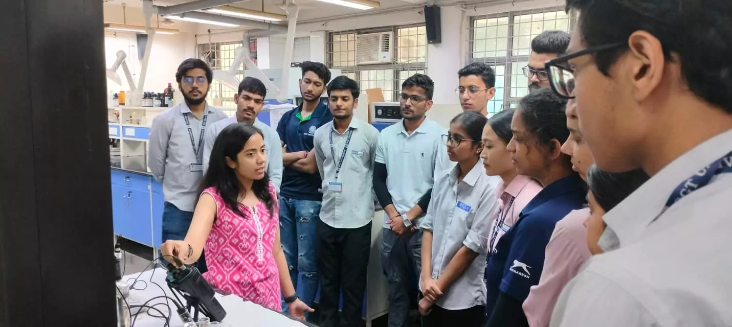Expert explaining lab equipment to students during their visit to Delhi Technological University